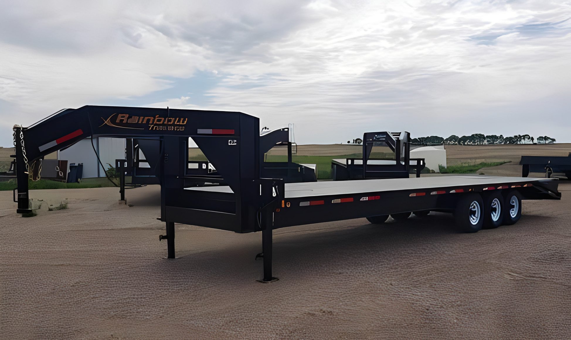 Triple-axle trailer in industrial area.