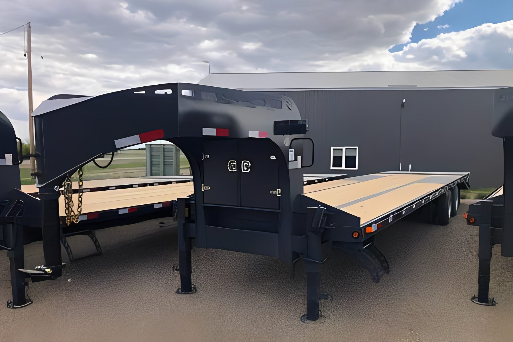 Industrial flatbed trailers under cloudy sky