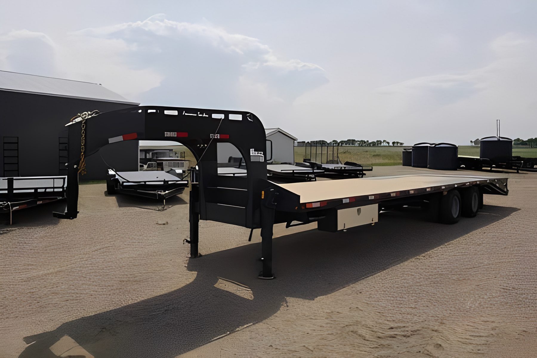 Large flatbed trailer on gravel surface