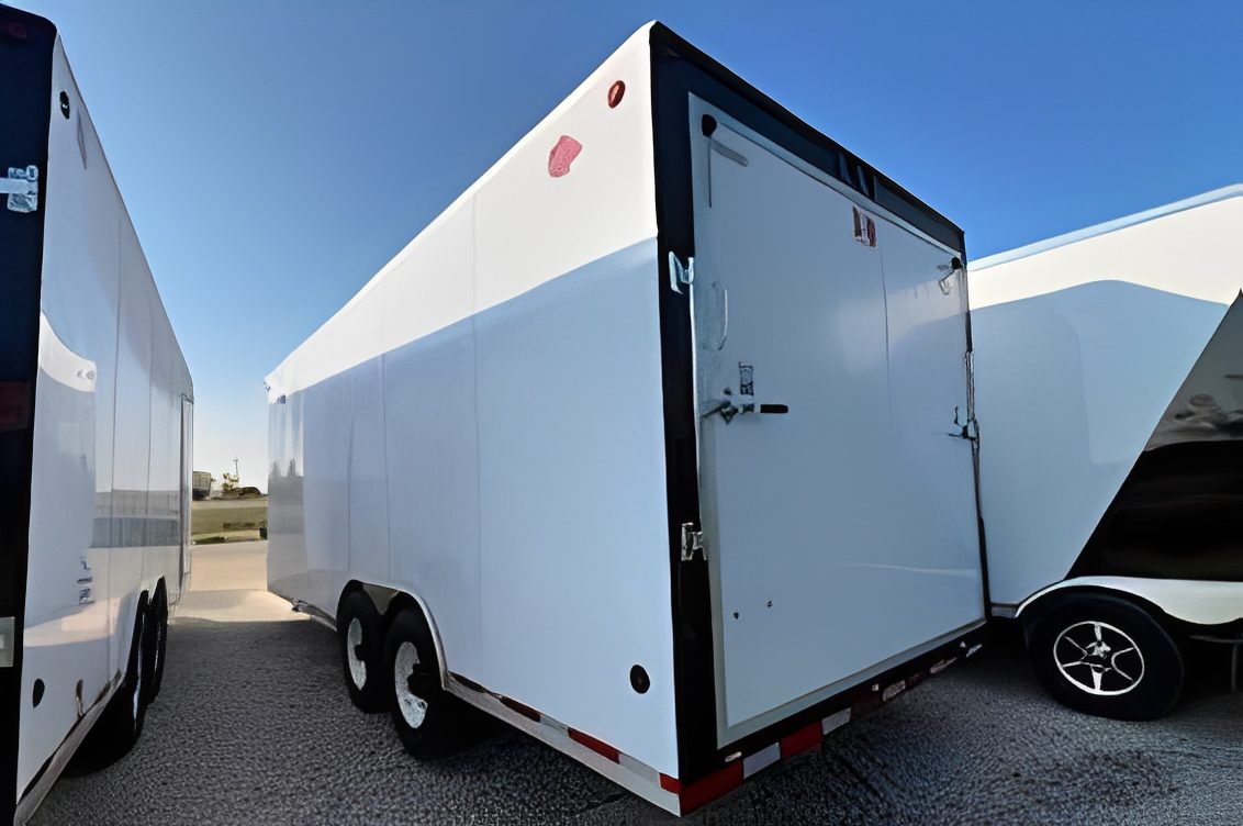 Enclosed trailer parked on gravel lot