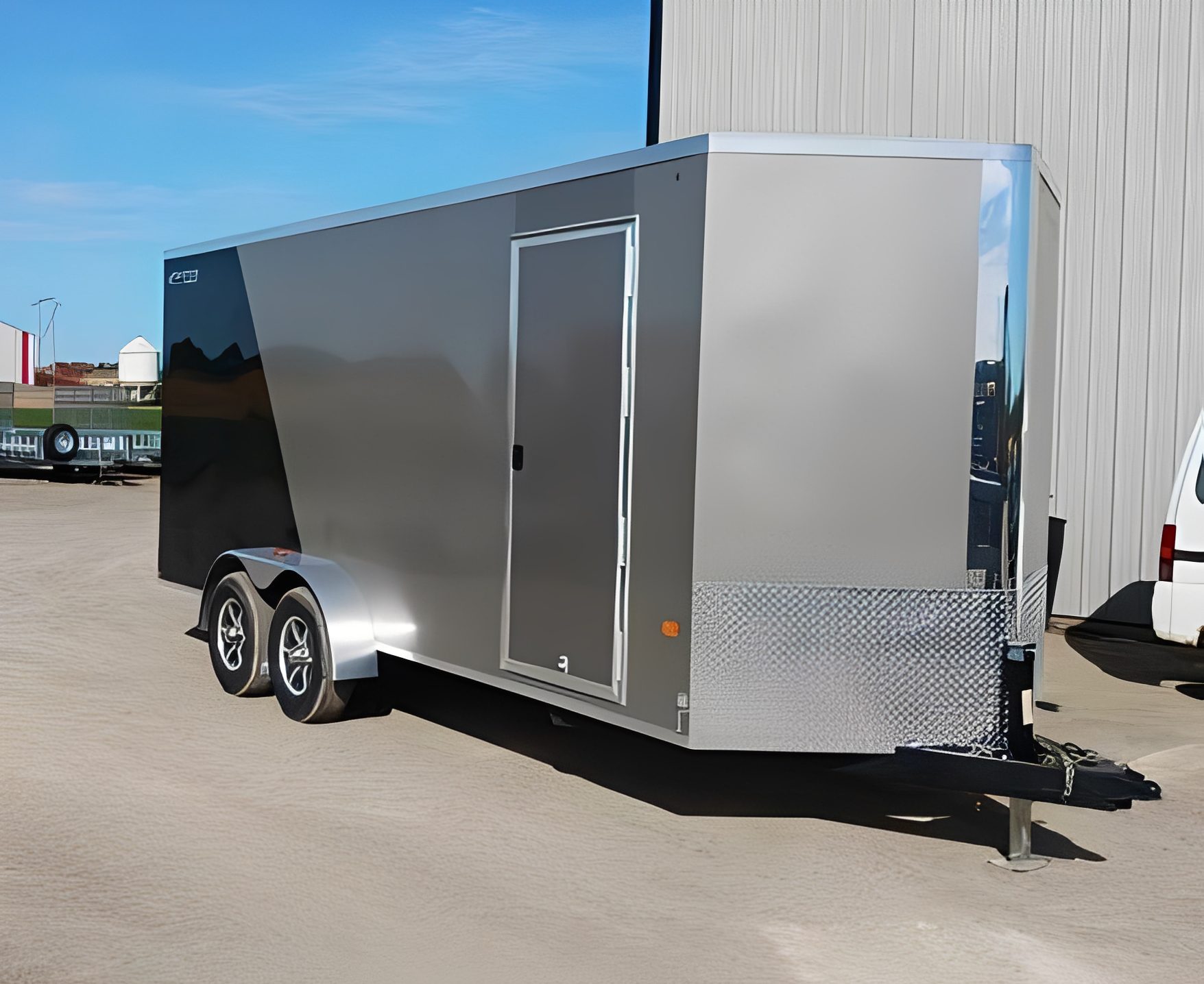 Sleek aluminum trailer under clear sky