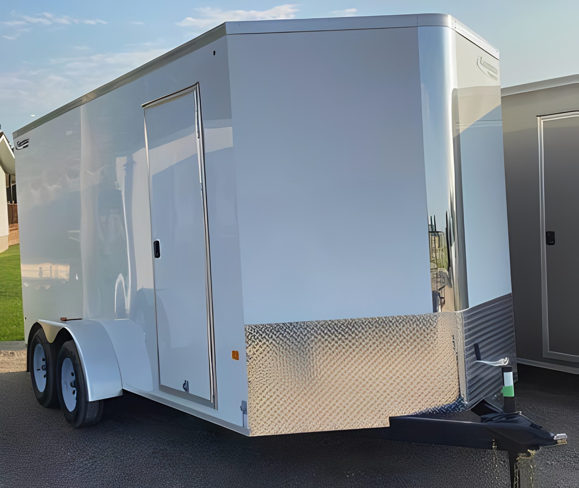 Enclosed white cargo trailer parked outside