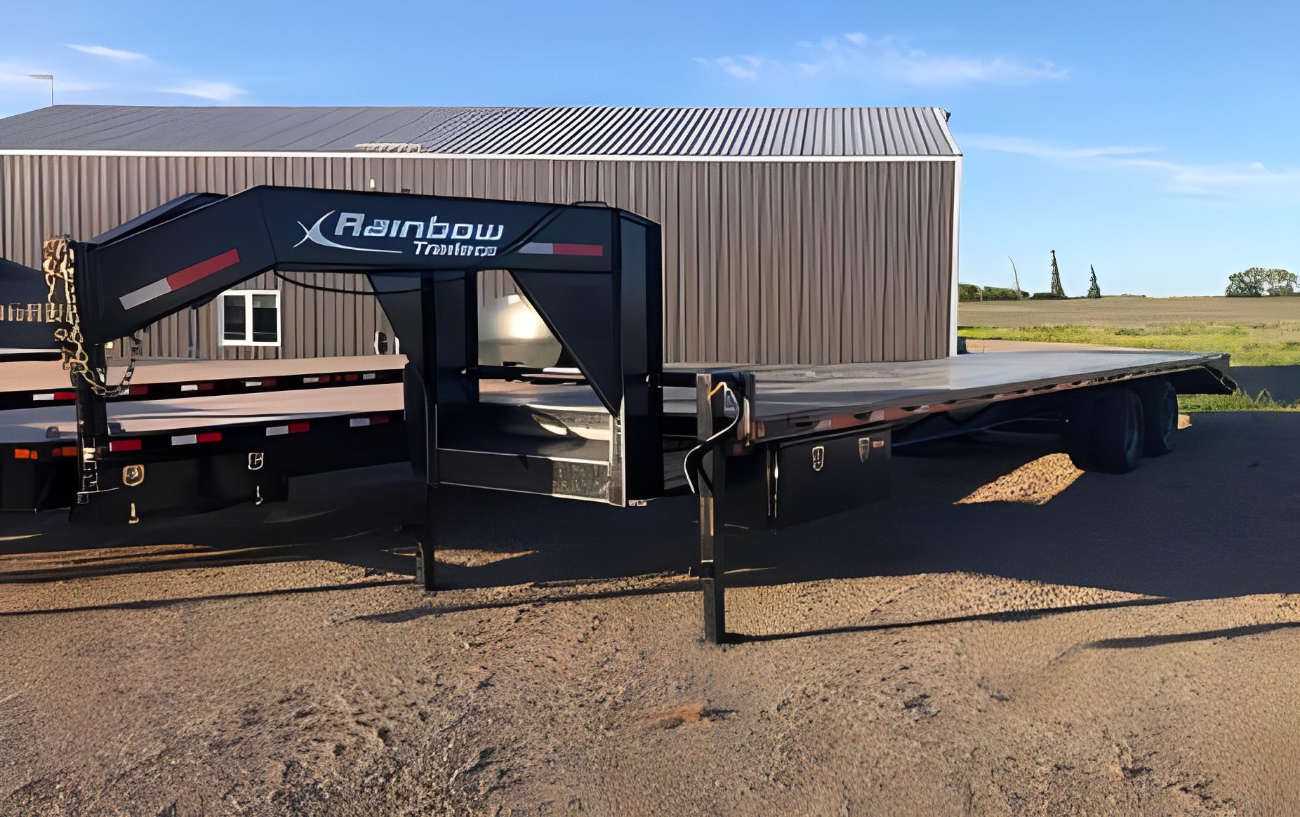 Flatbed trailer parked on gravel