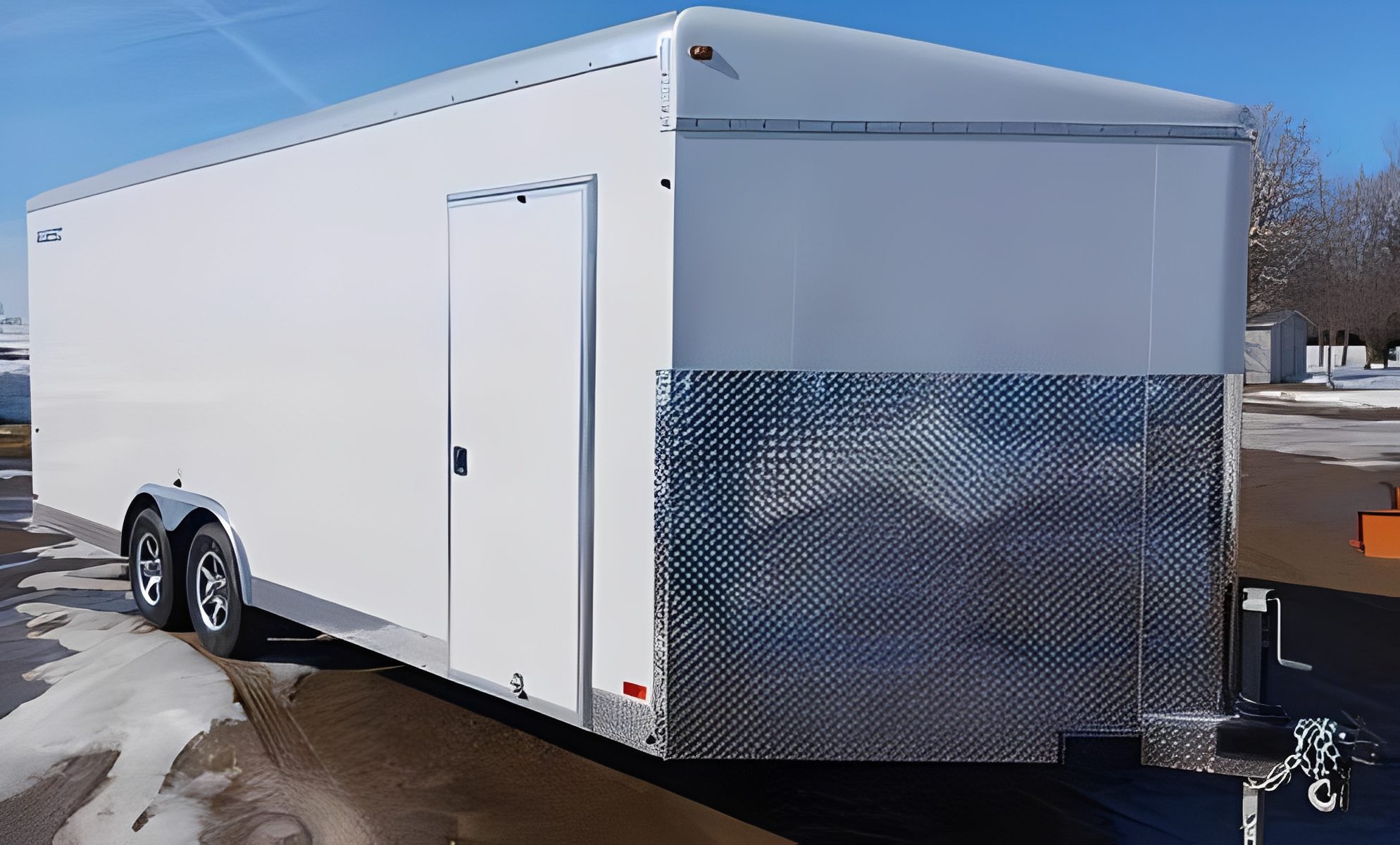 Enclosed cargo trailer with shiny front panel.