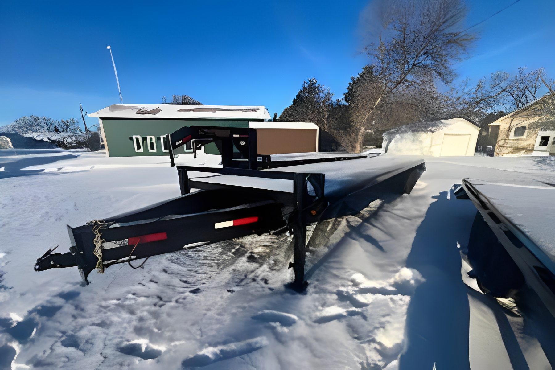 Snow-covered flatbed trailer in winter
