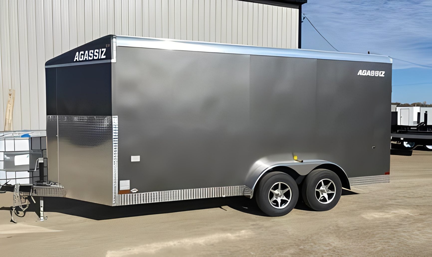 Metal trailer near industrial building.