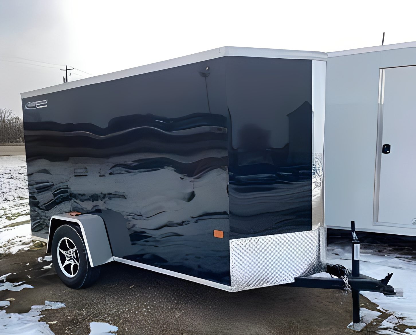 Black enclosed cargo trailer on snowy ground