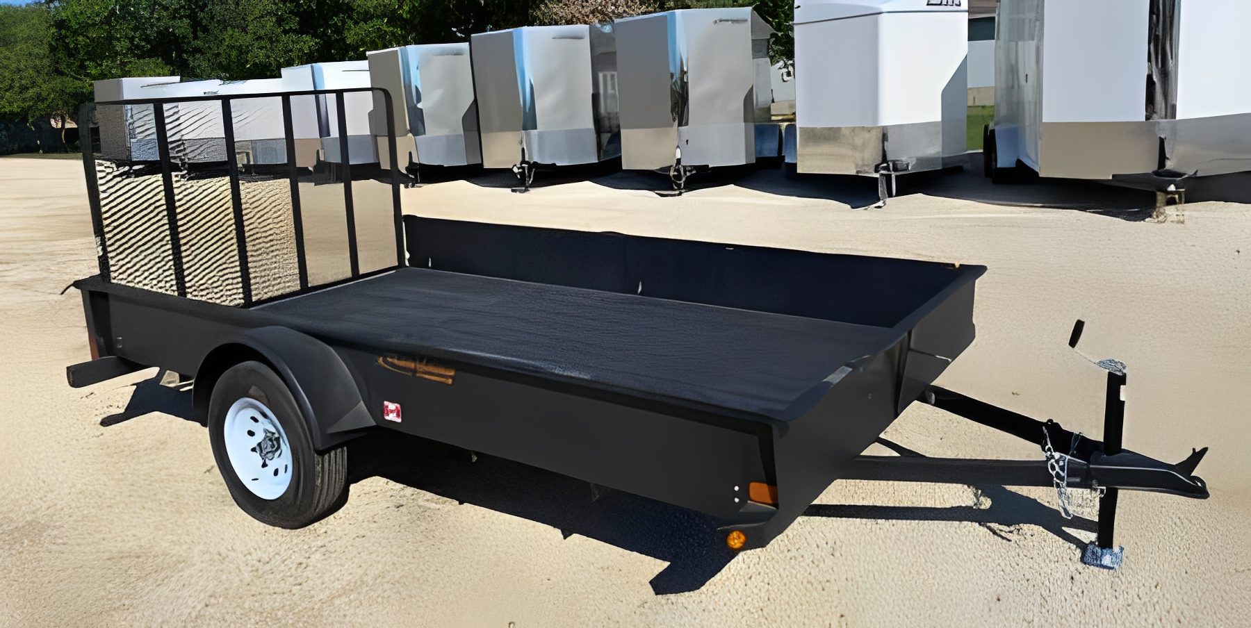 Utility trailer parked on sand lot