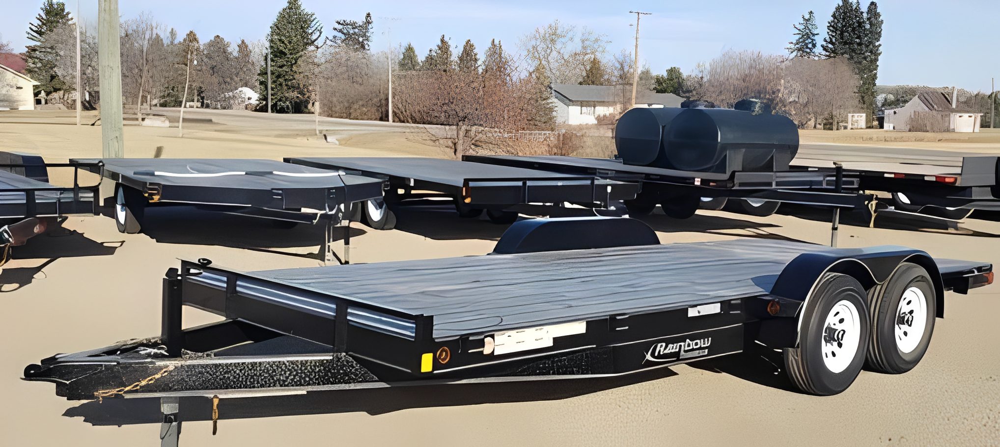 Flatbed trailer parked on gravel lot