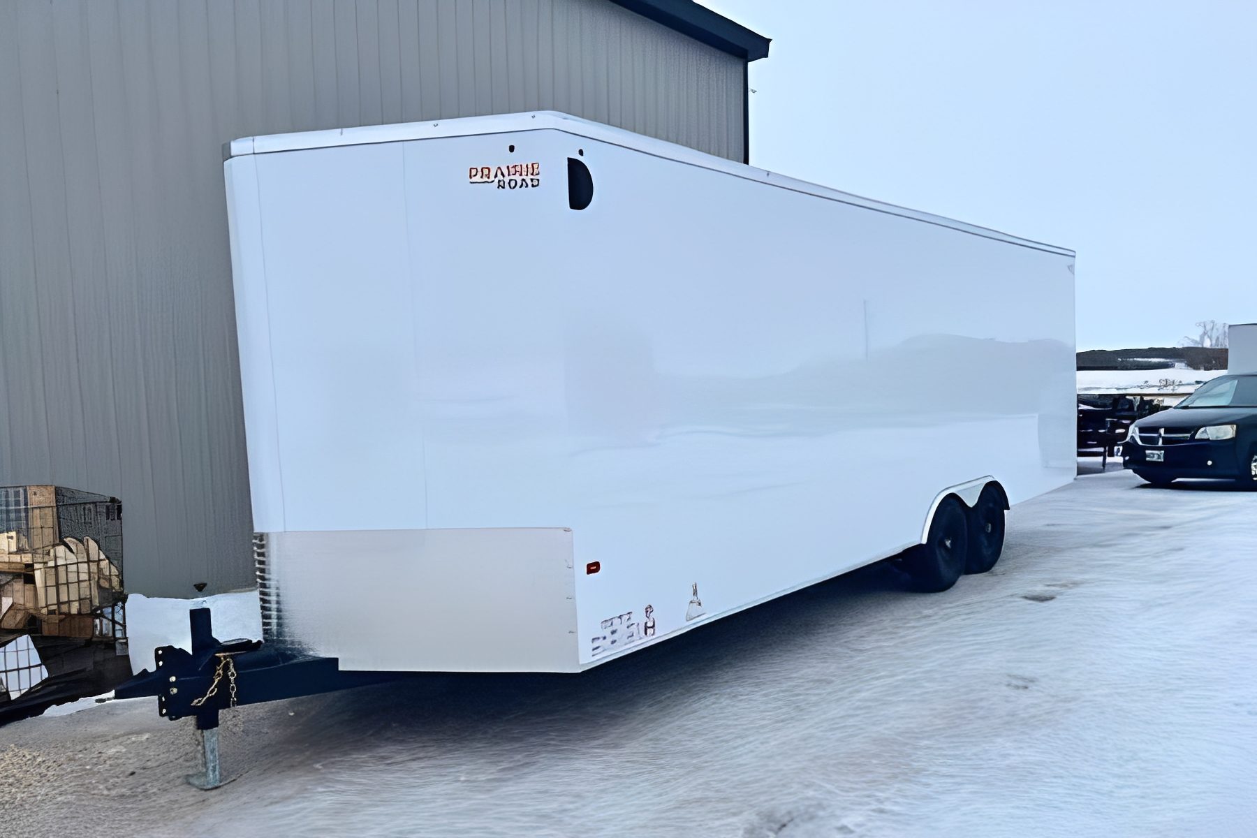 Large trailer parked beside building