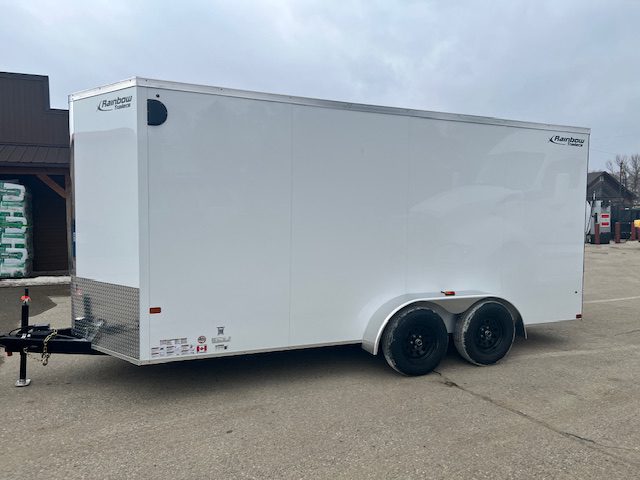 White enclosed dual-axle cargo trailer parked outdoors