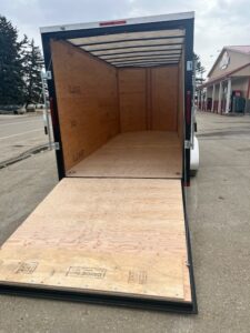 Open empty cargo trailer with ramp